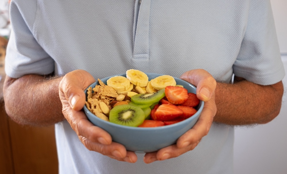 A senior man enjoying a fruit salad