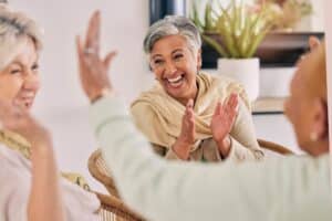 A happy senior woman laughing with her friends at the memory care assisted living in Concord, CA