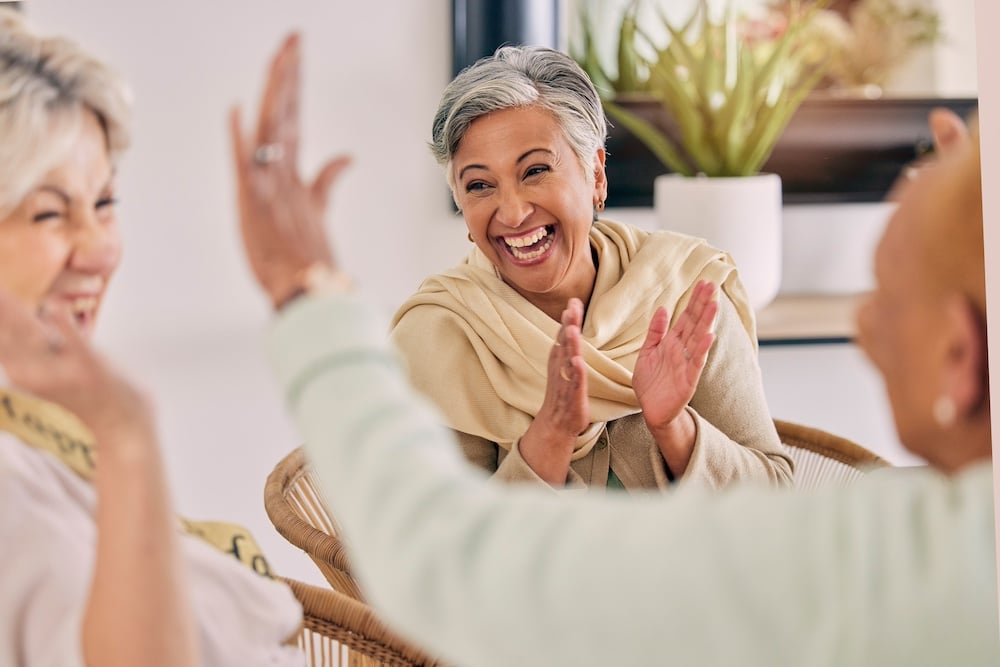 A happy senior woman laughing with her friends at the memory care assisted living in Concord, CA
