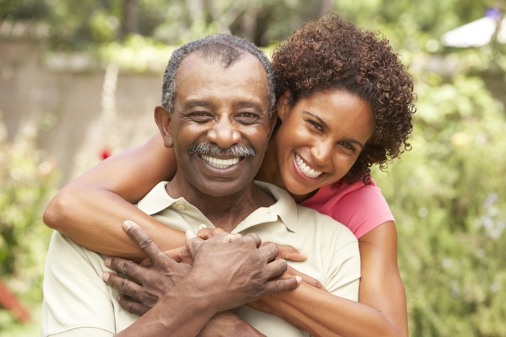 A senior man and his daughter hug during a visit at the Alzheimer's and dementia care in Concord, CA
